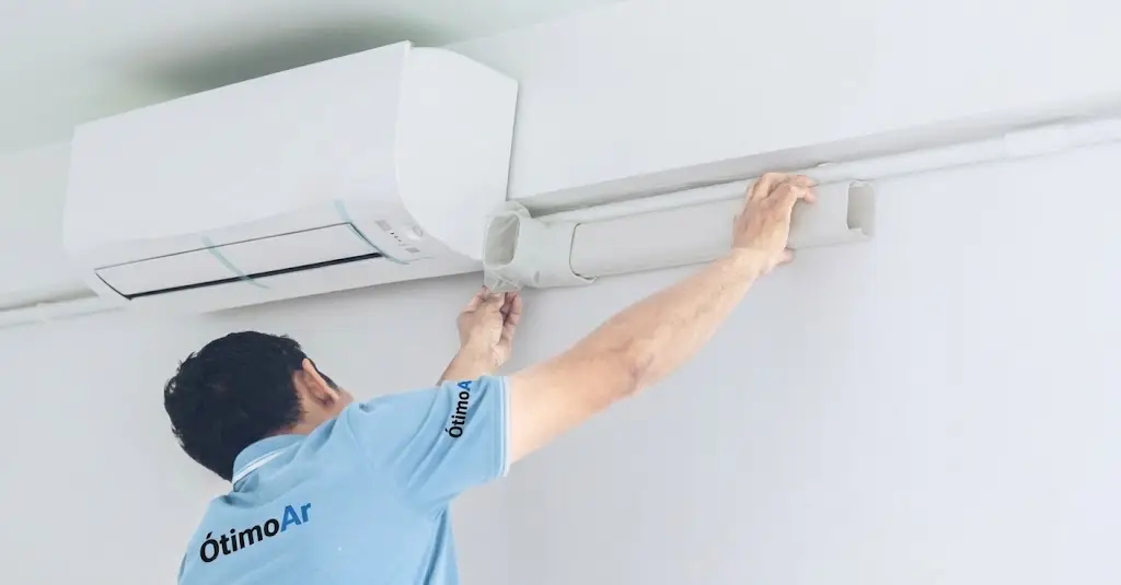 Técnico da Ótimo Ar instalando unidade split em parede residencial